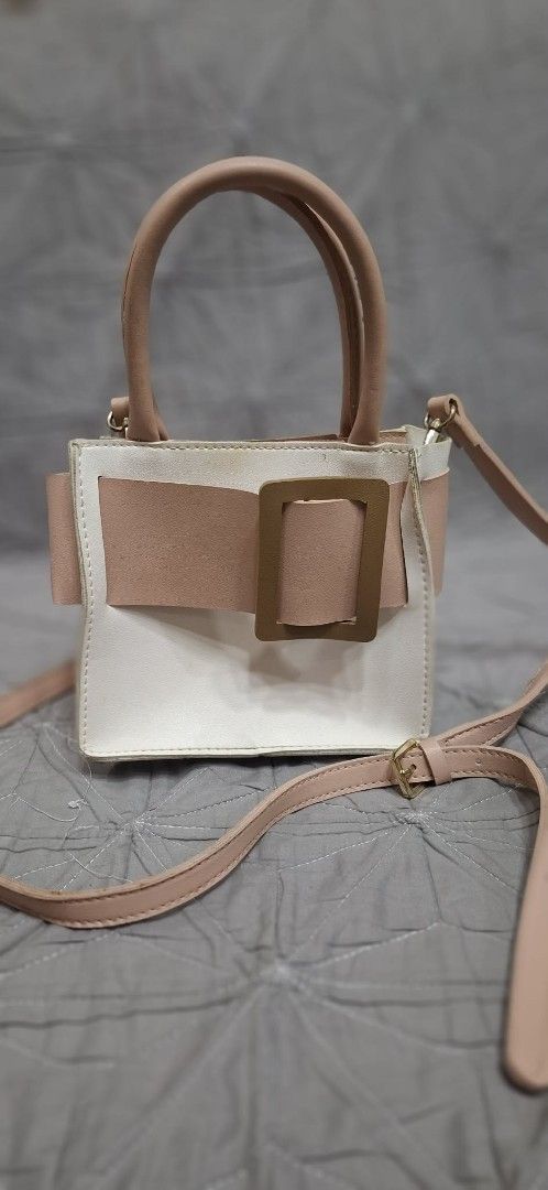 Pink and White Handbag with Buckle (Category: Shoulder Bags) located in Makati City. Submitted by icesena09 (Listing ID 1415023263, Image 2). Description: - Color block design in pink and white - Top handle - Detachable shoulder strap - Buckle closure - Interior pocket - Chic accessory for everyday use.