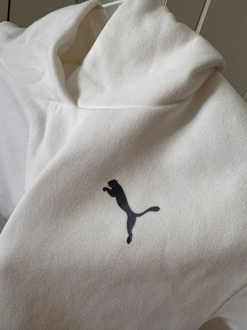 Puma White Hoodie (Category: Coats, Jackets and Outerwear) located in San Pedro. Submitted by ajcee (Listing ID 1414843169, Image 3). Description: - White Puma hoodie - Small Puma logo on chest - Large Puma logo on sleeve - High neckline - Long sleeves with black trim - Authentic Puma brand.