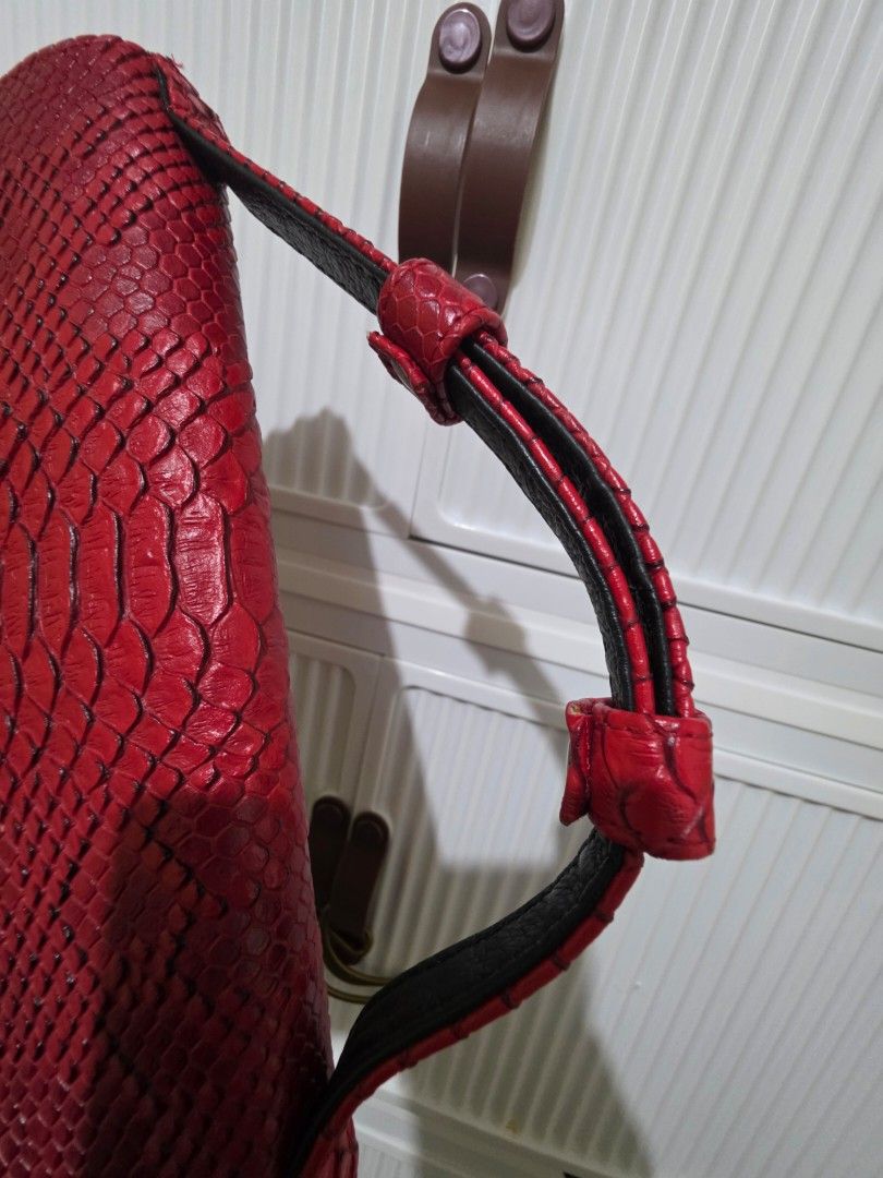 Red Snake Skin Clutch Bag (Category: Wallets & Card holders) located in Las Pinas. Submitted by andthelike (Listing ID 1415005790, Image 3). Description: - Red wallet with snake skin texture - Flap closure with snap button - Multiple compartments - Includes a zippered pocket - Black interior lining - Sleek, rectangular design - No sling included.