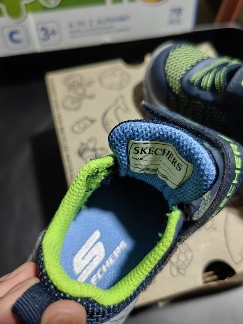 Skechers Toddler Shoes (Category: Babies & Kids Fashion) located in Bacoor. Submitted by acm.cm (Listing ID 1414927894, Image 2). Description: - Skechers toddler shoes - Navy blue and green color scheme - Hook-and-loop strap with Skechers logo - Gray soles with Skechers logo - Includes original box.