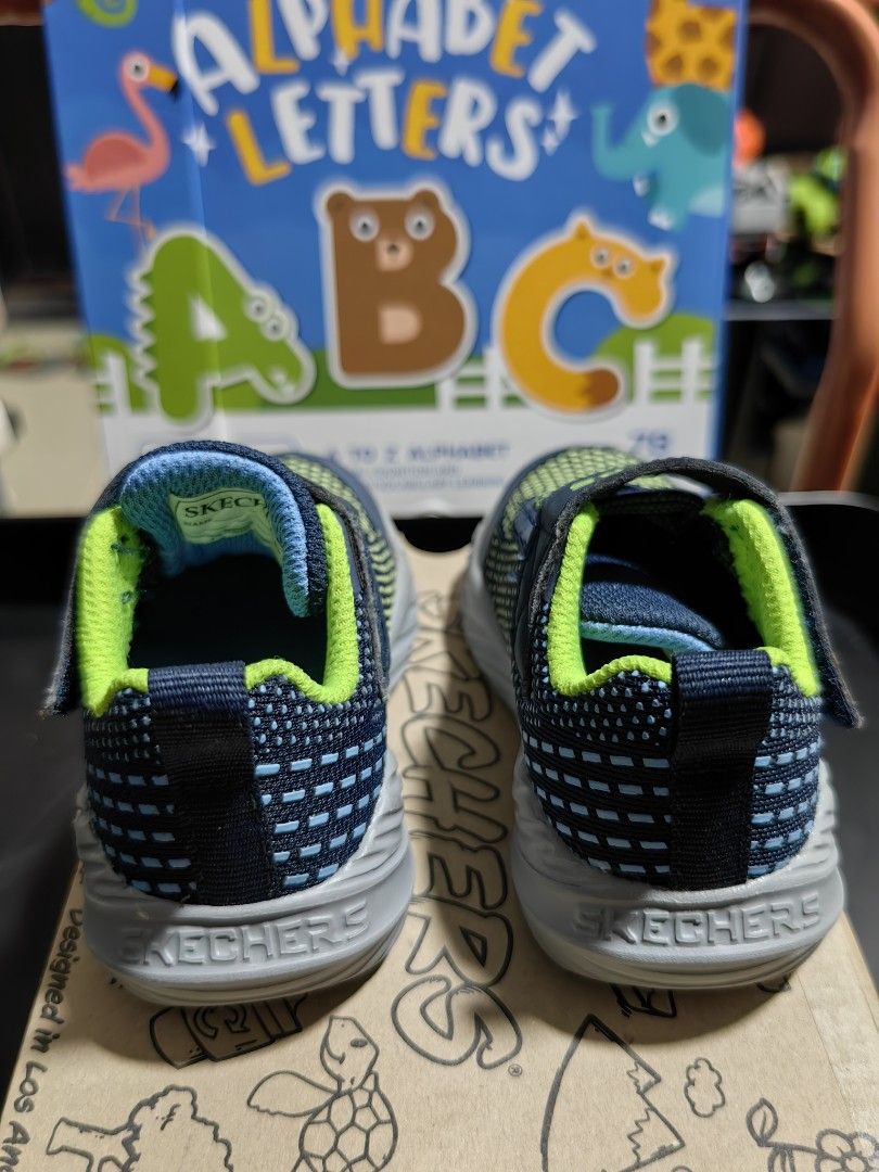Skechers Toddler Shoes (Category: Babies & Kids Fashion) located in Bacoor. Submitted by acm.cm (Listing ID 1414927894, Image 3). Description: - Skechers toddler shoes - Navy blue and green color scheme - Hook-and-loop strap with Skechers logo - Gray soles with Skechers logo - Includes original box.