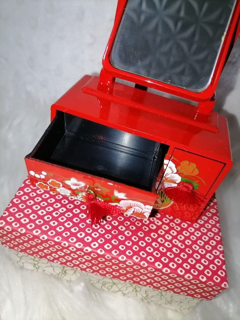 Vintage Red Vanity Set with Mirror (Category: Mirrors) located in Butuan. Submitted by az-branded.items (Listing ID 1414877918, Image 3). Description: - Vintage vanity set - Red lacquered finish with floral accents - Includes adjustable mirror - Features two small drawers with tassel - Comes with a patterned storage box - Compact and decorative.