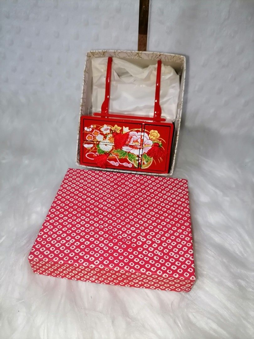 Vintage Red Vanity Set with Mirror (Category: Mirrors) located in Butuan. Submitted by az-branded.items (Listing ID 1414877918, Image 2). Description: - Vintage vanity set - Red lacquered finish with floral accents - Includes adjustable mirror - Features two small drawers with tassel - Comes with a patterned storage box - Compact and decorative.
