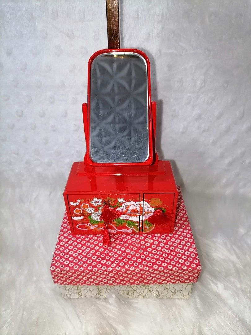Vintage Red Vanity Set with Mirror (Category: Mirrors) located in Butuan. Submitted by az-branded.items (Listing ID 1414877918, Image 1). Description: - Vintage vanity set - Red lacquered finish with floral accents - Includes adjustable mirror - Features two small drawers with tassel - Comes with a patterned storage box - Compact and decorative.