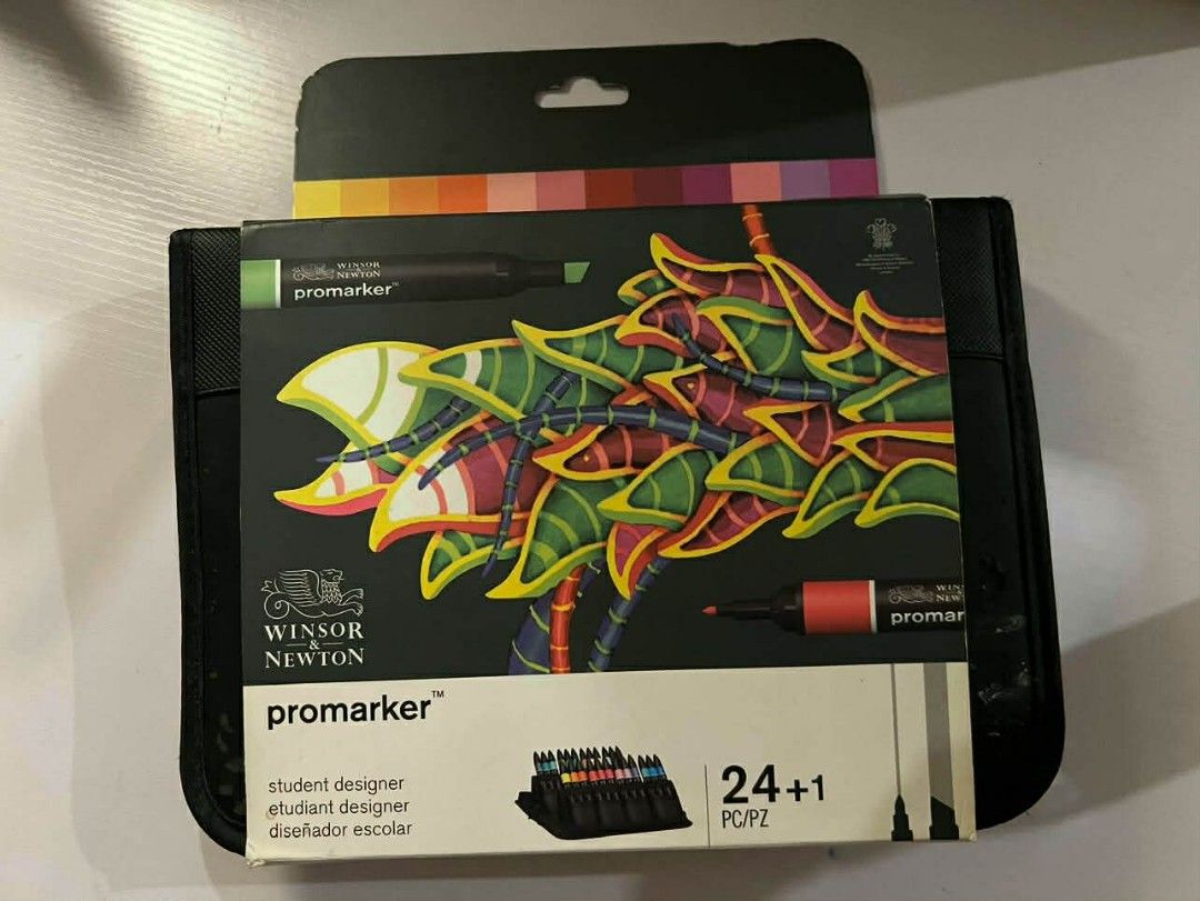 Winsor & Newton Promarker 24+1 Set (Category: Craft Supplies & Tools) located in Makati City. Submitted by msverify (Listing ID 1415026865, Image 2). Description: Winsor & Newton Promarker set with 24 markers and a blender. The set comes in a black case. The box shows the color range and the markers are dual-tipped. The set includes a variety of colors, including yellow, orange, red, pink, purple, blue, and green. The markers are student designer