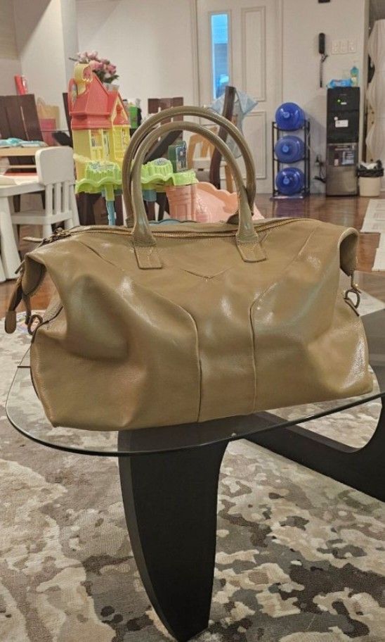 YSL-Inspired Boston Bag (Category: Luxury Bags & Wallets) located in Makati City. Submitted by mrsdm (Listing ID 1414106242, Image 2). Description: - Tan leather handbag - Top handles and detachable shoulder strap - Rectangular shape with structured design - Secure zipper closure - Spacious interior - Matching tan handles - Ideal for everyday use.