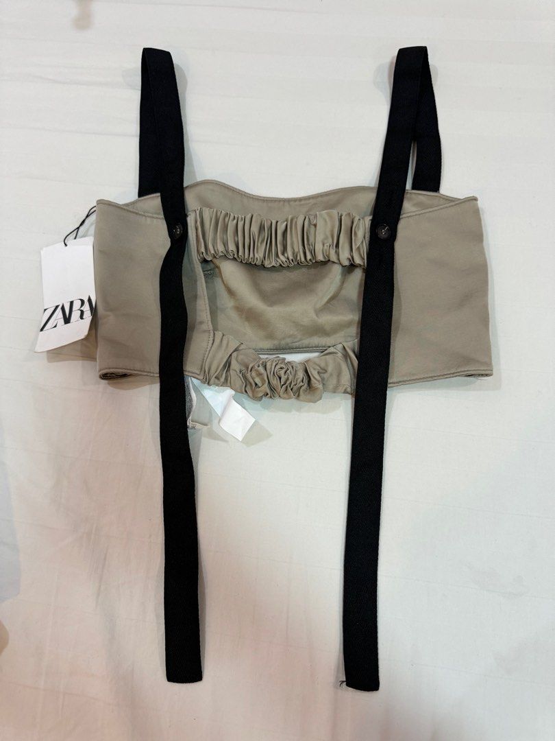 Zara Strappy Crop Top - Size S (Category: Sleeveless) located in Manila. Submitted by audsy (Listing ID 1414963488, Image 2). Description: - Zara strappy crop top (Size S) - Beige front with black straps - Button details at the back - Includes original tag - Unique gathered back design - Structured front - Perfect for a stylish, modern look.