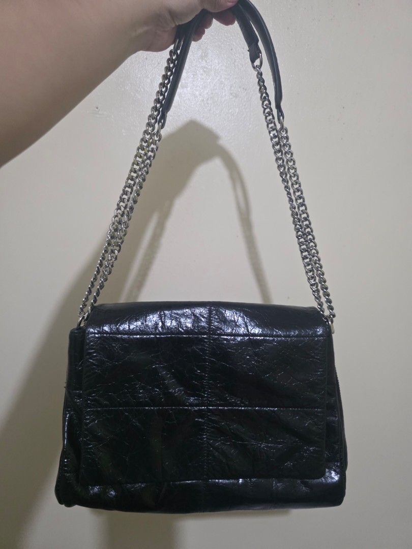 Zishen Black Shoulder Bag with Chain Strap (Category: Shoulder Bags) located in Las Pinas. Submitted by andthelike (Listing ID 1414996275, Image 1). Description: Black shoulder bag with a chain strap. Features multiple compartments. White canvas Interior lining Glossy distressed exterior Silver hardwares.