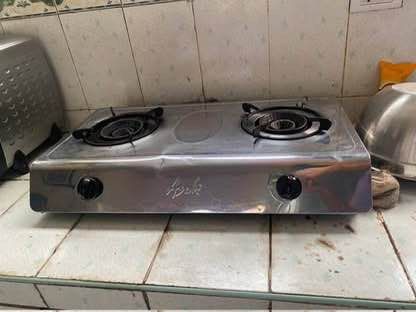 2-Burner Gas Stove (Category: Cookware & Accessories) located in San Juan City. Submitted by terminator00 (Listing ID 1415225435, Image 1). Description: - Stainless steel 2-burner gas stove - Features two black knobs for burner control - In good working condition - Perfect for cooking various dishes - Compact design, fits most kitchens.