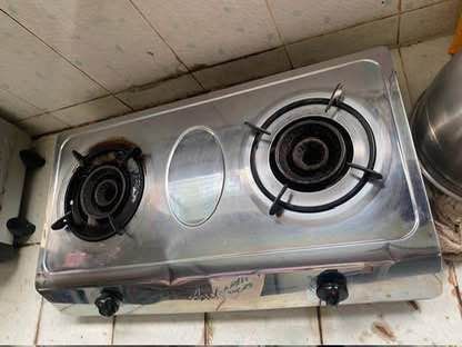 2-Burner Gas Stove (Category: Cookware & Accessories) located in San Juan City. Submitted by terminator00 (Listing ID 1415225435, Image 3). Description: - Stainless steel 2-burner gas stove - Features two black knobs for burner control - In good working condition - Perfect for cooking various dishes - Compact design, fits most kitchens.