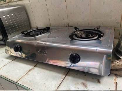 2-Burner Gas Stove (Category: Cookware & Accessories) located in San Juan City. Submitted by terminator00 (Listing ID 1415225435, Image 2). Description: - Stainless steel 2-burner gas stove - Features two black knobs for burner control - In good working condition - Perfect for cooking various dishes - Compact design, fits most kitchens.