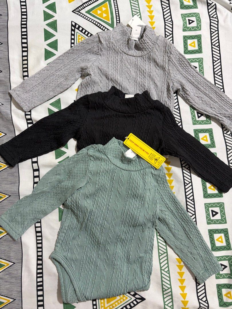 Long Sleeves for Baby (Category: Babies & Kids Fashion) located in San Fernando. Submitted by akcd12 (Listing ID 1415084296, Image 1). Description: - Set of three long sleeve baby bodysuits - Colors: Gray, Black, and Green - Features a stylish turtleneck design - Textured knit pattern - Green bodysuit has convenient snap closure at the bottom - All items are brand new with tags attached.