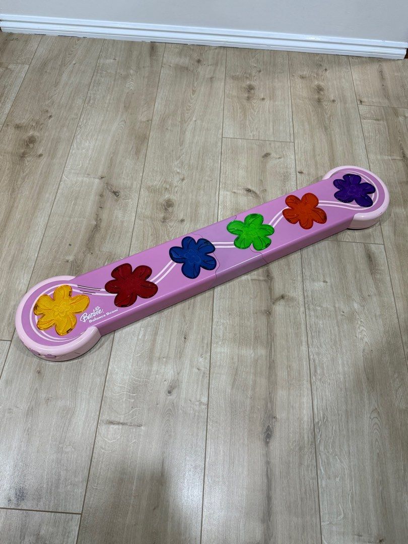 Barbie Balance Beam (Category: Kids Toys) located in Paranaque City. Submitted by rymss (Listing ID 1415157076, Image 1). Description: - Pink Barbie balance beam - Features flower accents - Includes flower-shaped cutouts - Barbie logo visible - Made of plastic.