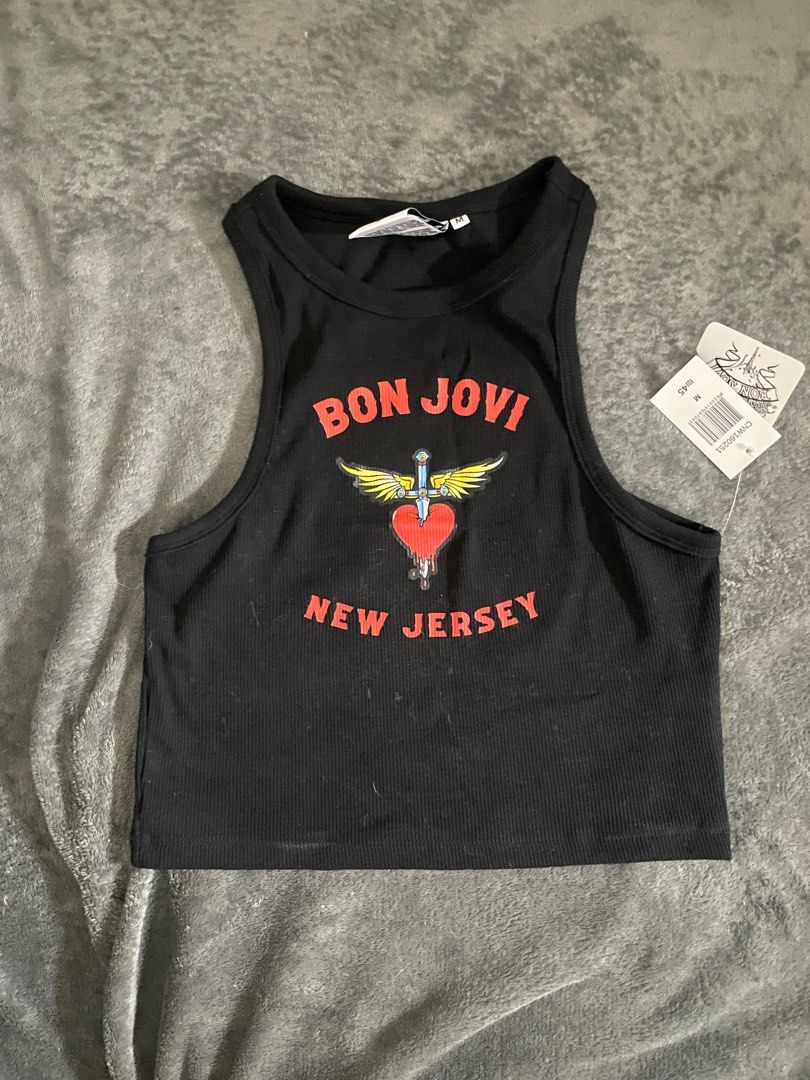 Bon Jovi Tank Top - Black (Category: Sleeveless) located in Rizal. Submitted by declutterwsky (Listing ID 1415219510, Image 1). Description: - Bon Jovi tank top - Features the Bon Jovi logo with a heart and wings design - Text: "BON JOVI" and "NEW JERSEY" - Size: M - Ribbed texture - Brand logo visible on inner tag.