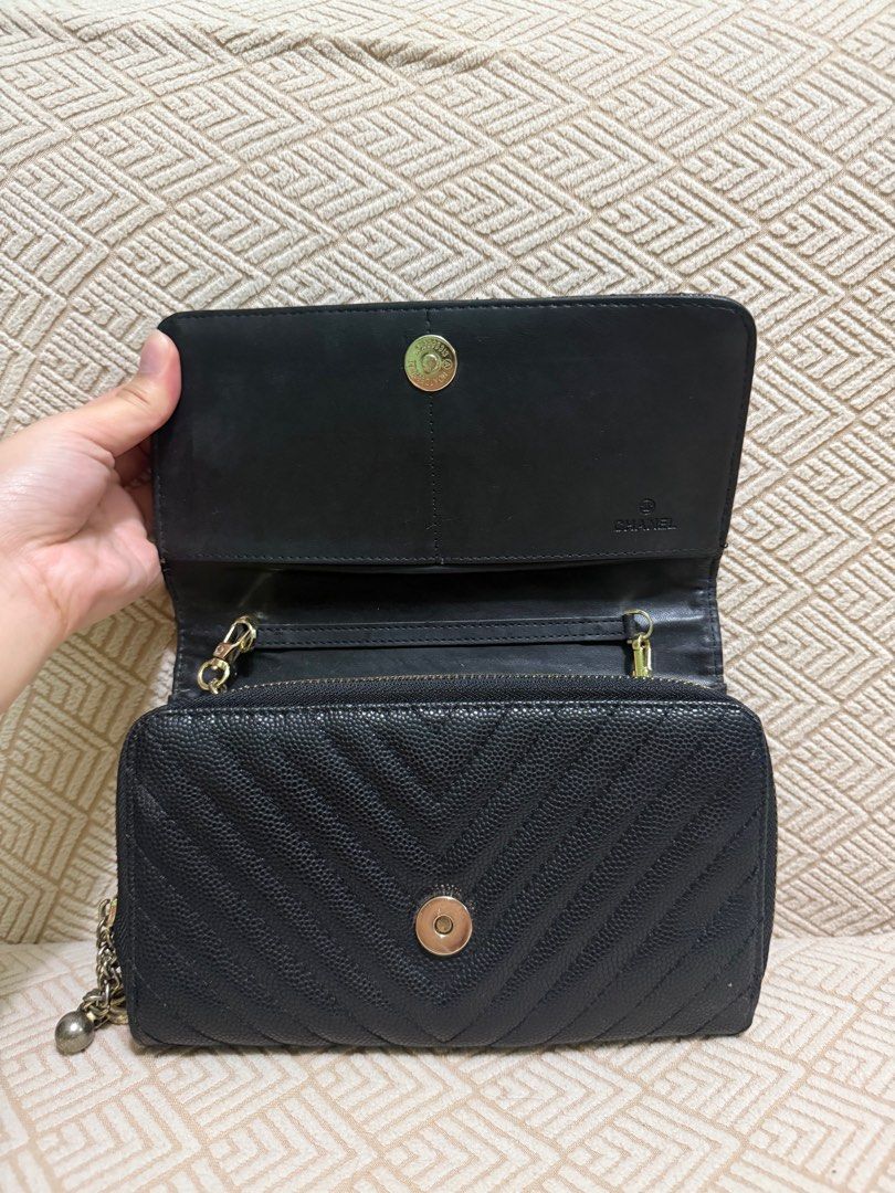 Chanel Chevron Wallet on Chain (Category: Luxury Bags & Wallets) located in Manila. Submitted by jj11662 (Listing ID 1415174520, Image 3). Description: - Chanel wallet - Black with chevron design - Gold-tone Chanel logo - Chain strap - Flap closure - Multiple compartments - Zippered pocket - Textured leather finish.
