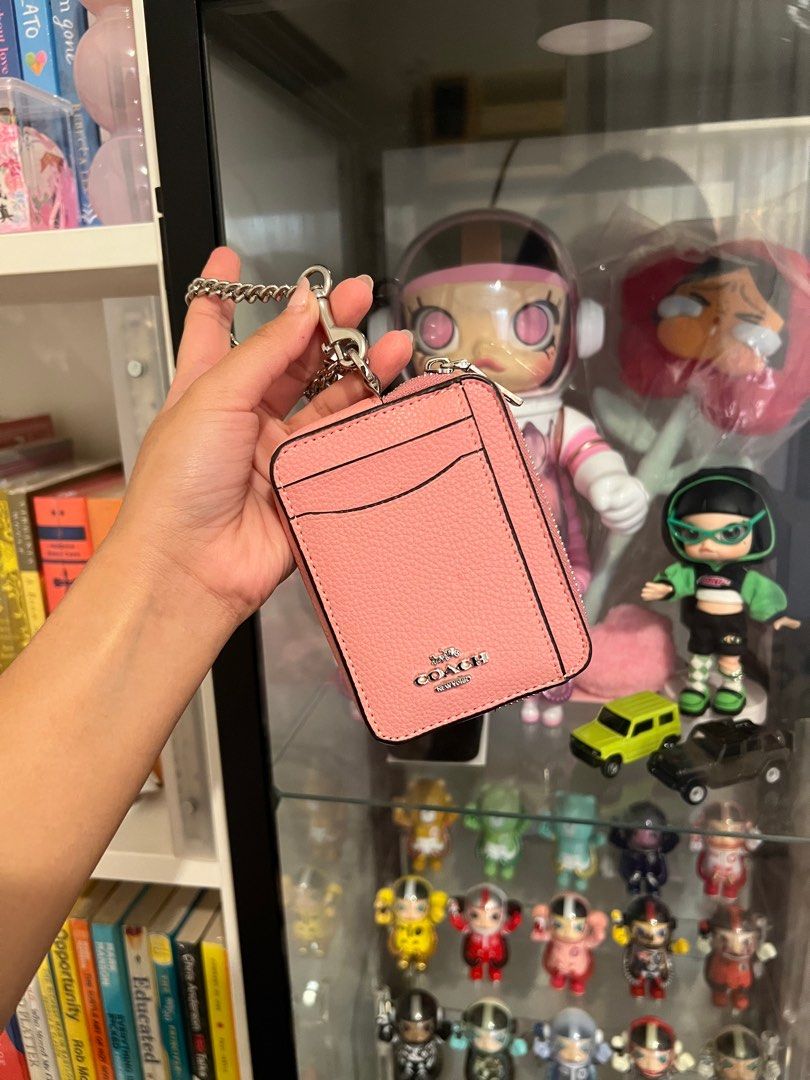 Coach Pink Card Case with Chain (Category: Luxury Bags & Wallets) located in Pasay City. Submitted by chii.b (Listing ID 1415142857, Image 1). Description: Coach card case is a lovely pink color. It features a zip-around closure and a chain for easy carrying. The front has card slots and the back has a clear window. The original tag is still attached. Inside, there are multiple compartments for cards and cash..