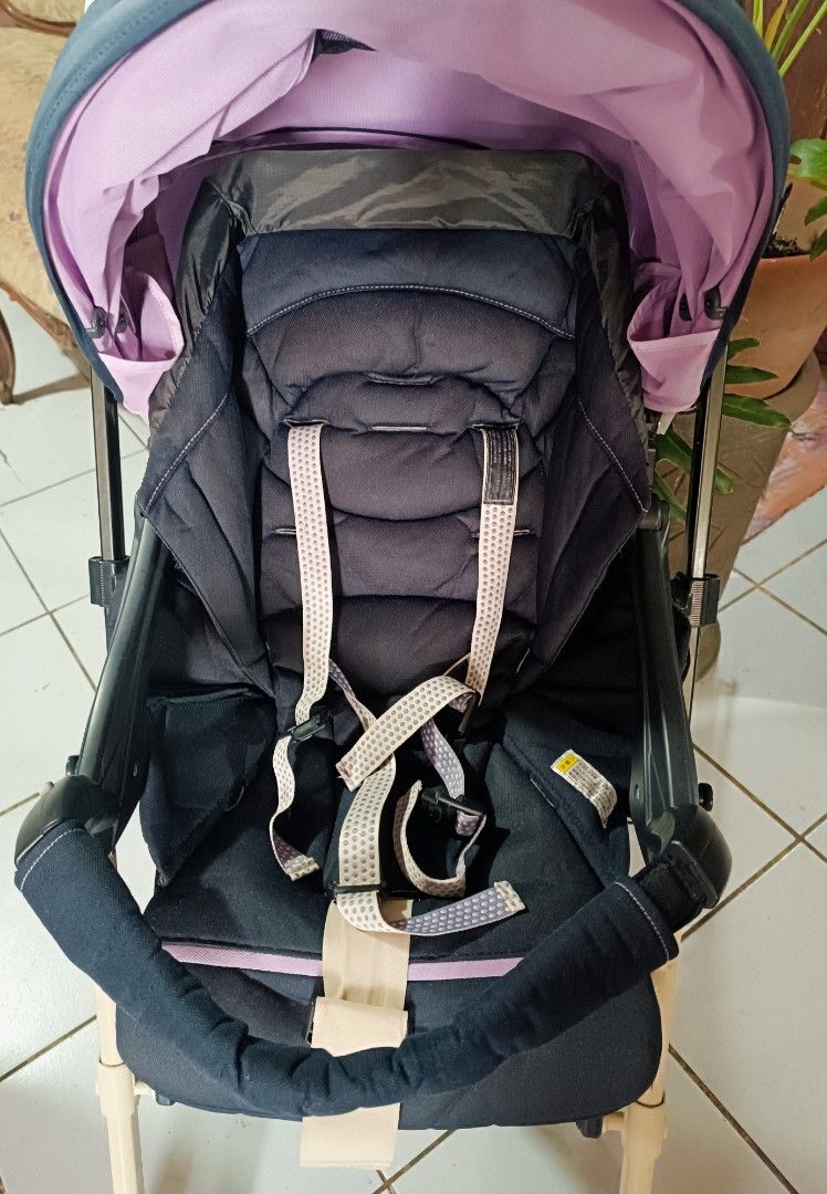 Combi Stroller (Category: Strollers) located in Manila. Submitted by ofwmom (Listing ID 1415056727, Image 2). Description: - Combi stroller with a stylish navy blue and pink design. - Includes a sunshade for added protection. - Equipped with a safety harness for your child's security. - Features a comfortable brown handle. - Sturdy beige frame with durable black wheels. - Authentic Combi logo on the handle and footrest..