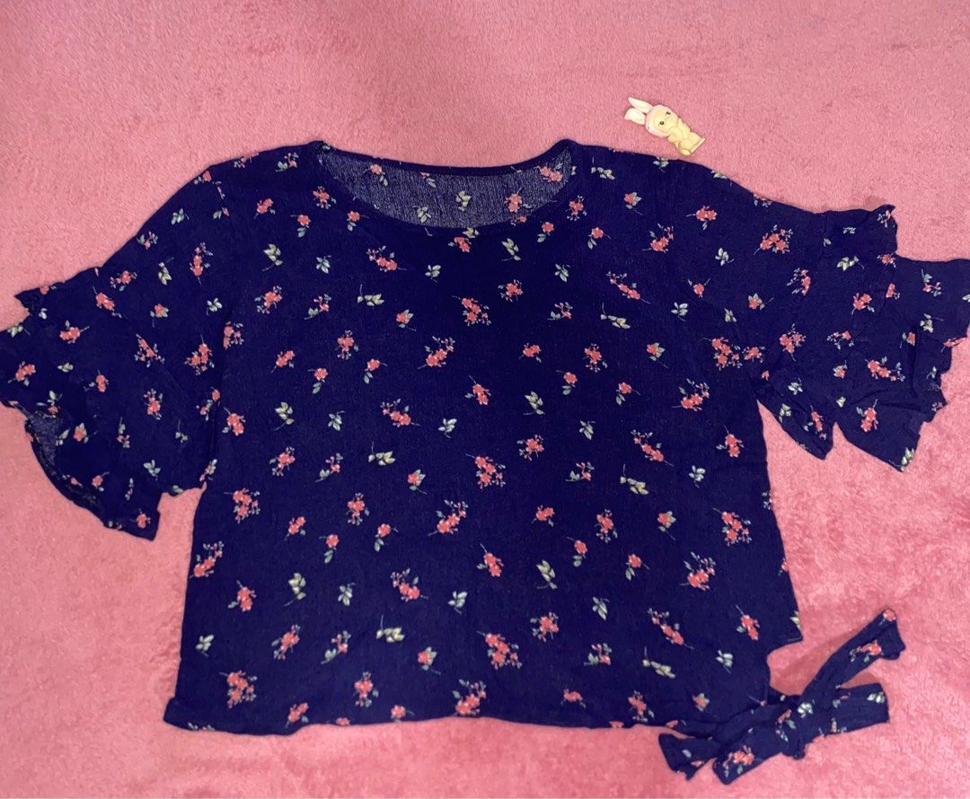 Floral Navy Blouse with Ruffle Sleeves (Category: Blouses) located in Manila. Submitted by rielilac (Listing ID 1415150425, Image 1). Description: - Navy blue blouse - Floral pattern - Ruffle sleeves - Tie detail on the side - Lightweight fabric - Casual wear.