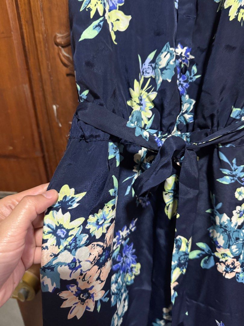 Floral Print Jumpsuit (Category: Jumpsuits) located in Palayan City. Submitted by decluttering_2018 (Listing ID 1415179978, Image 2). Description: - Navy blue floral print jumpsuit - Features a V-neckline - Sleeveless design - Tie-waist detail - Button closure - Includes pockets - Wide-leg cut - One-piece outfit.