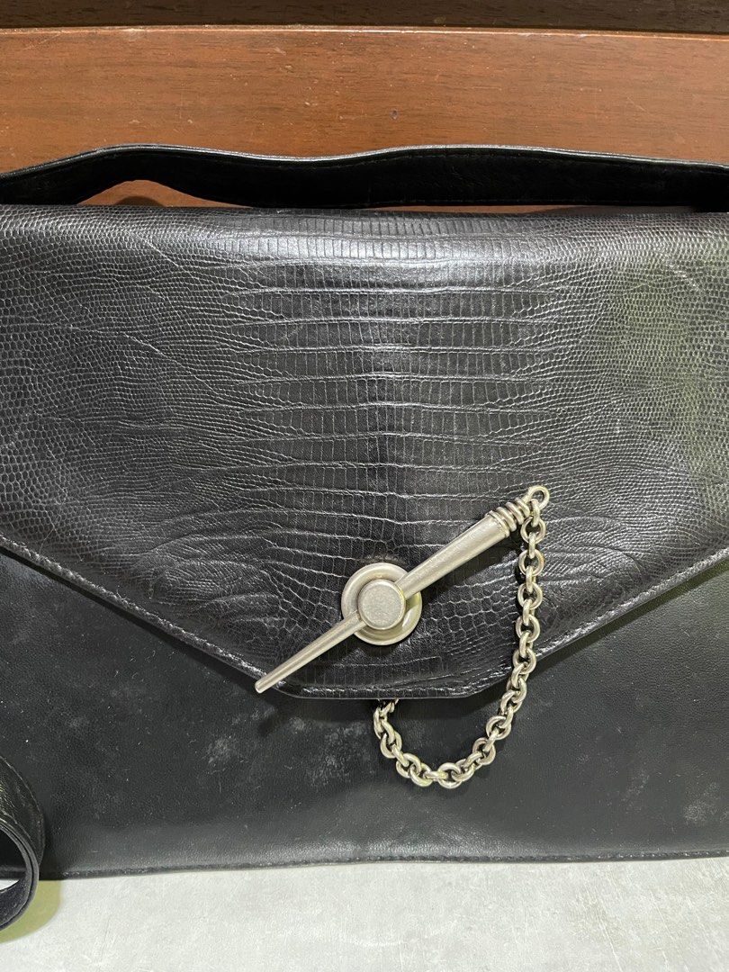 Gianni Versace Leather Crossbody Bag (Category: Luxury Bags & Wallets) located in Bacnotan. Submitted by anosellmo (Listing ID 1415041713, Image 2). Description: - Gianni Versace crossbody bag - Black leather - Silver-tone hardware - Textured flap with chain detail - Adjustable long strap - Multiple interior compartments - Zippered pocket - Signature patterned lining.