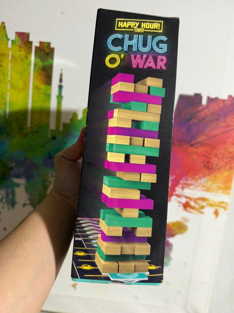 Happy Hour Tower Chug O' War Game (Category: Board Games & Puzzles) located in Mandaluyong City. Submitted by bufifinds (Listing ID 1415231668, Image 2). Description: - Happy Hour Tower Chug O' War: The ultimate adult party game! - Includes: 48 wooden blocks, 24 cards, and a gameboard. - Gameplay: Slide the tower and complete fun challenges! - Age: 21 and up. - Features: Eye-catching neon box design. - Includes: Easy-to-follow instructions..