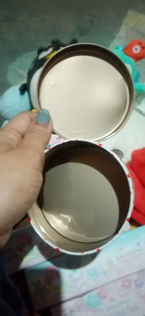 Hello Kitty Round Tin Box (Category: Storage Boxes & Baskets) located in Bulacan. Submitted by renasophiatoystore2020 (Listing ID 1415130534, Image 3). Description: - Adorable Kitty round tin box. - Features a white lid with a red Kitty design. - Gold-colored interior. - Includes a label with Japanese characters. - Perfect for collectors!.