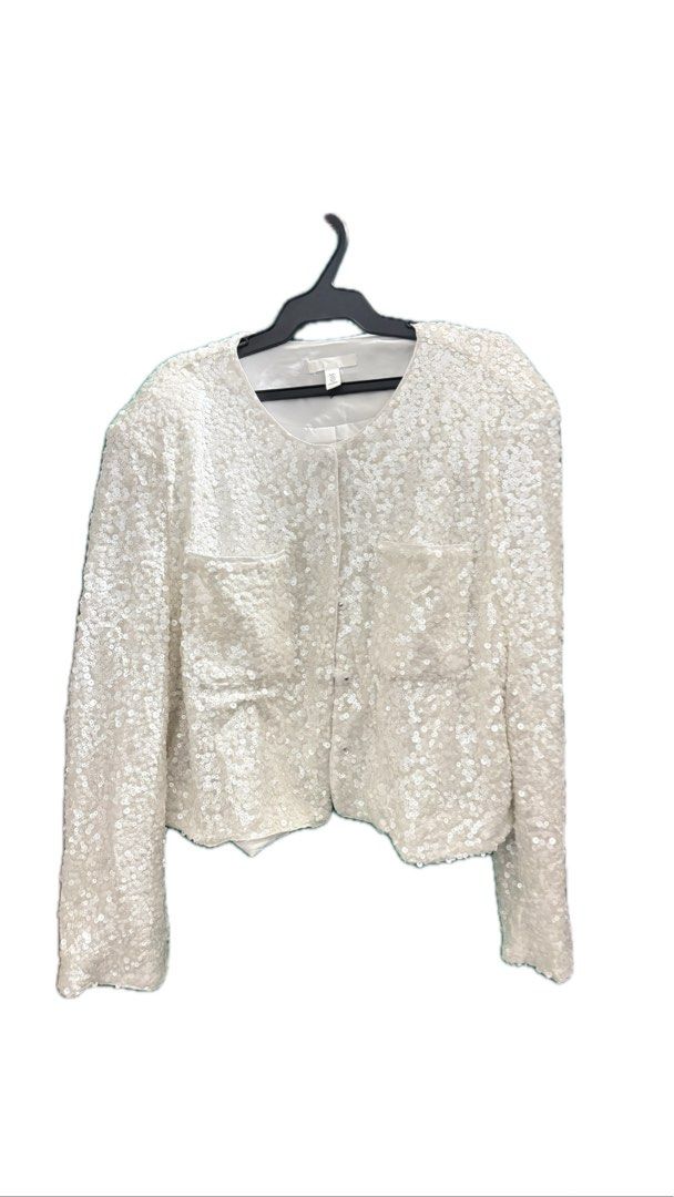 H&M Sequined blouse (Category: Coats, Jackets and Outerwear) located in Taguig. Submitted by httpgrant (Listing ID 1415223918, Image 3). Description: - WORN ONCE, like brand new - bought for 1,299 - Short blouse in sequined mesh with a round neckline, concealed press-studs down the front, patch chest pockets and long sleeves. Lined. - White sequin jacket - Round neckline - Long sleeves - Button closure - Two front pockets - Adds sparkle to any ou