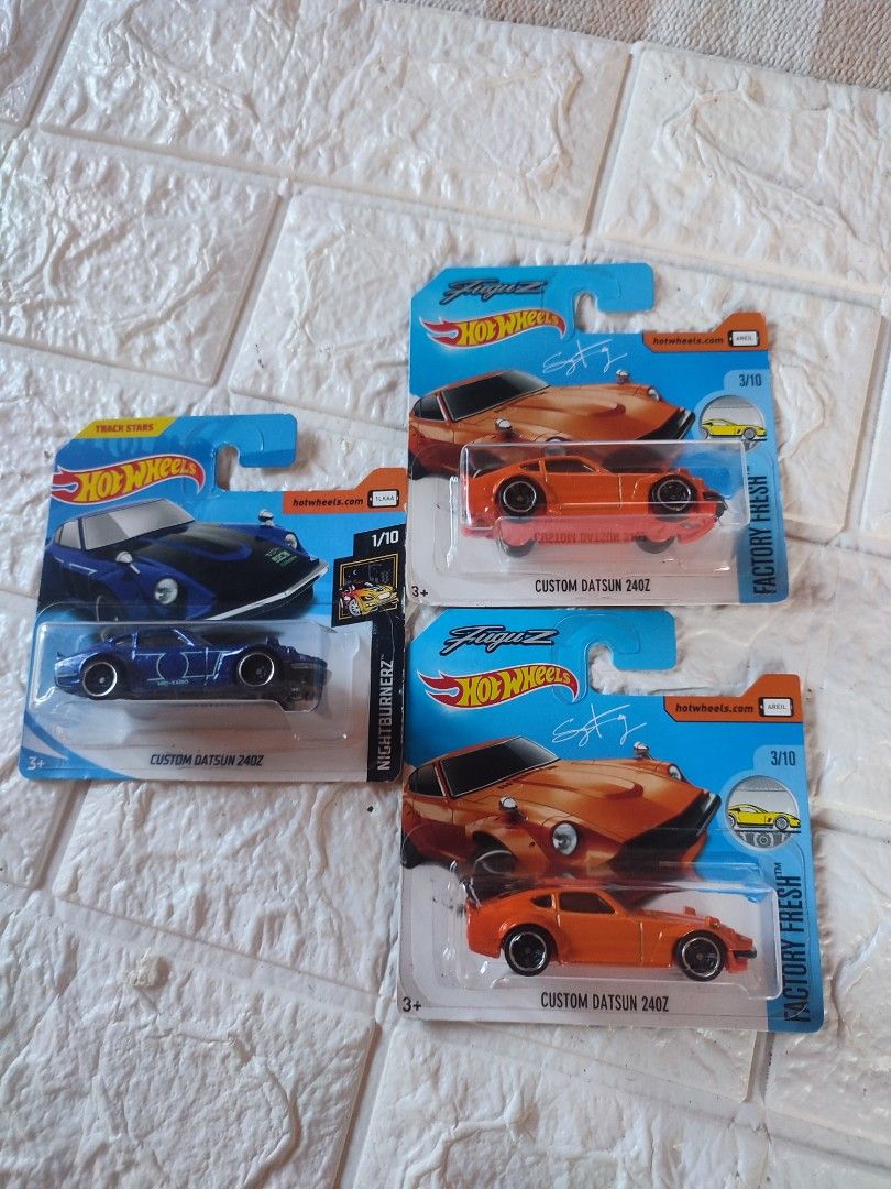 Hot Wheels Custom Datsun 240Z (Category: Vehicle & Diecast Models) located in Narvacan. Submitted by jigger85 (Listing ID 1415125037, Image 1). Description: - Hot Wheels Custom Datsun 240Z - Available colors: 2 Orange, 1 Blue - Orange cars: Factory Fresh series - Blue car: Nightburnerz series - All cars are in original packaging.