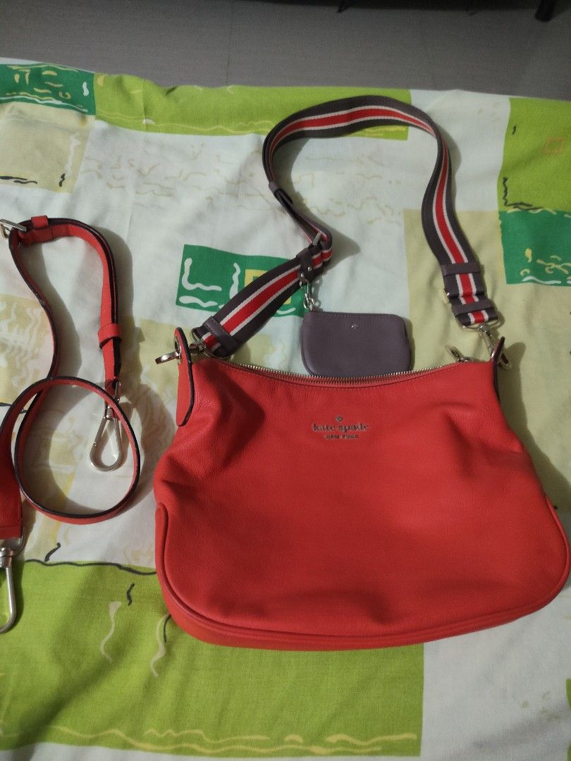 Kate Spade Red Shoulder Bag (Category: Luxury Bags & Wallets) located in Manila. Submitted by allaboutzara (Listing ID 1415162586, Image 1). Description: - Kate Spade shoulder bag - Vibrant red orange color - Includes: - Striped shoulder strap - Red crossbody strap - Matching coin purse - Zippered closure - Kate Spade logo on front.