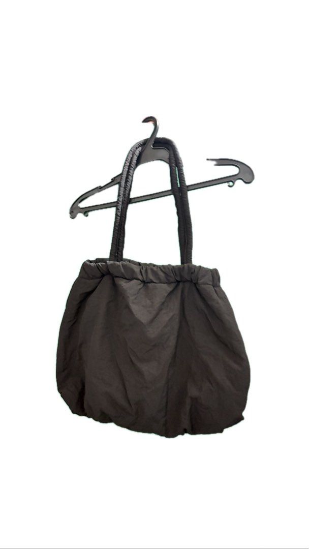 Medium sized puffy bag (Category: Tote Bags) located in Taguig. Submitted by httpgrant (Listing ID 1415225142, Image 2). Description: - Puffy, padded design - Drawstring closure - Two shoulder straps - Available colors: Black and Light purple - Smooth, possibly nylon-like material - Great size for everyday use.