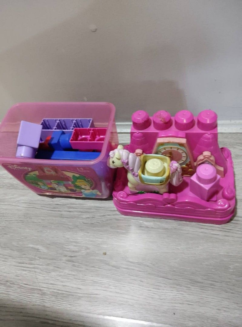 Mega Bloks Princess Carriage (Category: Kids Toys) located in Quezon City. Submitted by torricograces (Listing ID 1415232577, Image 2). Description: - Mega Bloks Princess Carriage set - Features a pink carriage, horse, clock, and decorative blocks - Includes a storage container filled with additional blocks - Perfect for imaginative play - Great for young children who love building and princesses.