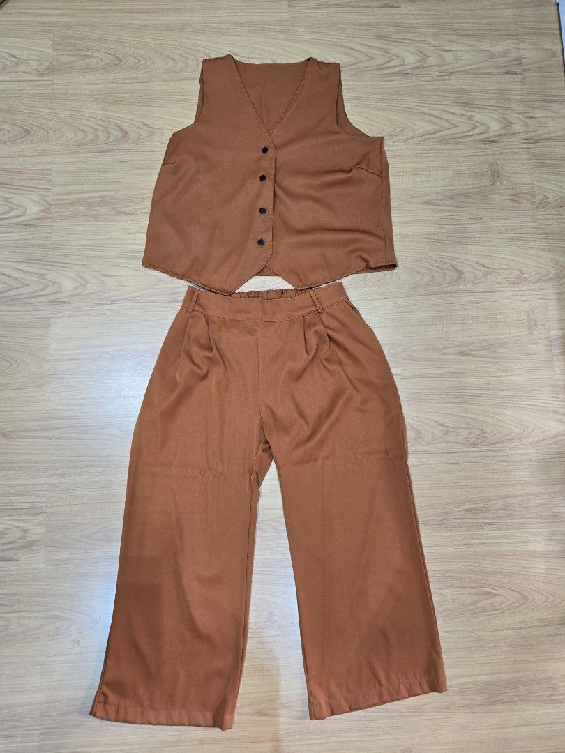 Plus Size Brown Vest and Pants Co-ord Set (Category: Sets or Coordinates) located in Antipolo. Submitted by zafthrift (Listing ID 1415157048, Image 1). Description: - Brown co-ord set - Includes vest and wide-leg pants - Vest features button details and V-neck - Made of smooth, woven fabric - Perfect for casual or dressy occasions Color: Brown Caramel Dimensions (in inches): Top Length - 25 Bust - 46 Pants Waist - 30-42 Hips - 50 Length - 38.5 No