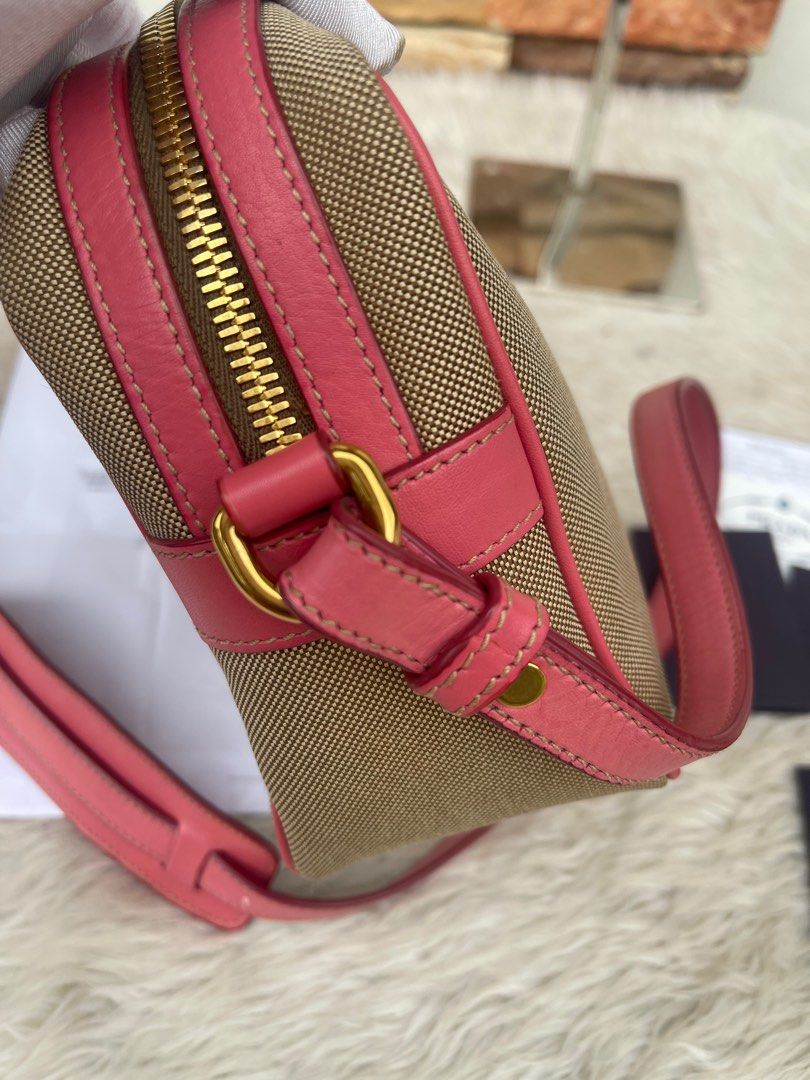 Prada Crossbody Bag with Bow Detail (Category: Luxury Bags & Wallets) located in Cavite. Submitted by authenticfindsbyging (Listing ID 1415044749, Image 2). Description: - Authentic Prada crossbody bag - Canvas body with pink leather trim - Features a bow detail - Gold-tone zipper and hardware - Prada-branded fabric lining - Includes detachable strap - Comes with authenticity cards and receipt.