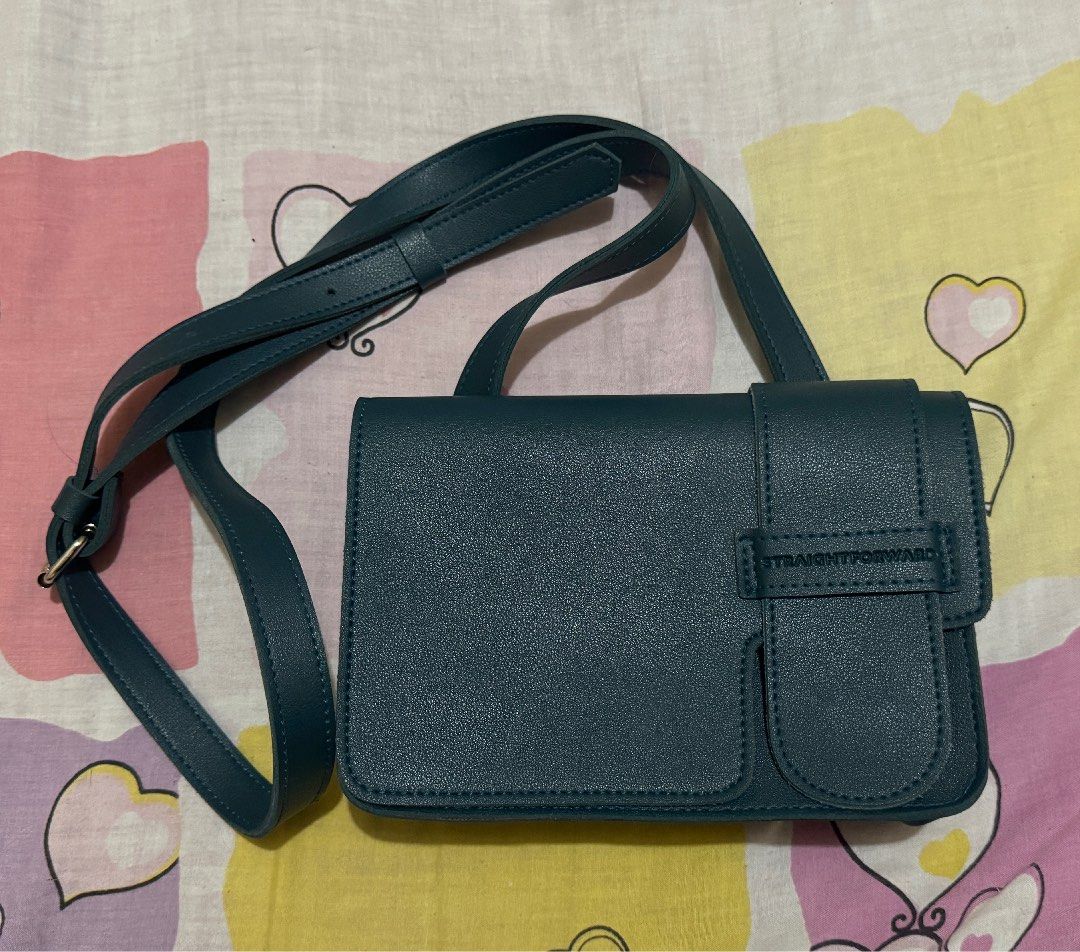 Straightforward DVL Noiva Crossbody Bag (Category: Cross-body Bags) located in Manila. Submitted by prem_universe (Listing ID 1415196153, Image 1). Description: - Straightforward crossbody bag - Teal color - Flap closure with buckle - Adjustable long strap - Soft interior lining - Fits phone, wallet, and small notebook rfs: bought it to match with my mom but not really my style - available for meet up (ubelt area) and same day delivery (lalamove)