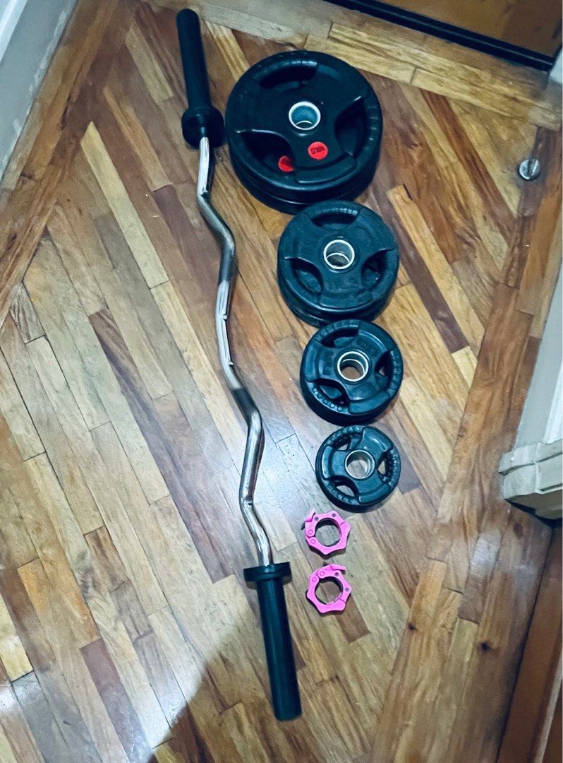 Technogym EZ Curl Barbell Set with Weights (Category: Weights & Dumbbells) located in Makati City. Submitted by destash_princess (Listing ID 1415079869, Image 1). Description: - Original Technogym EZ curl barbell for comfortable grip - Includes weight plates for varied workout intensity weight plates non branded - Pink collars to secure weights - Ideal for home strength training.