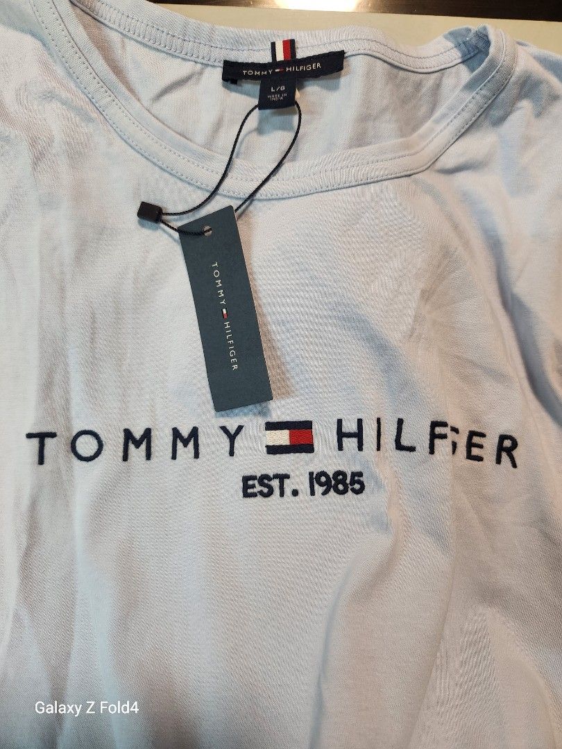 Tommy Hilfiger Light Blue Dress (Category: Dresses) located in Valenzuela. Submitted by allbrandedshop (Listing ID 1415086343, Image 3). Description: - Tommy Hilfiger dress - Light blue color - Round neckline - Short sleeves - Tie-waist detail - Tommy Hilfiger logo on front .