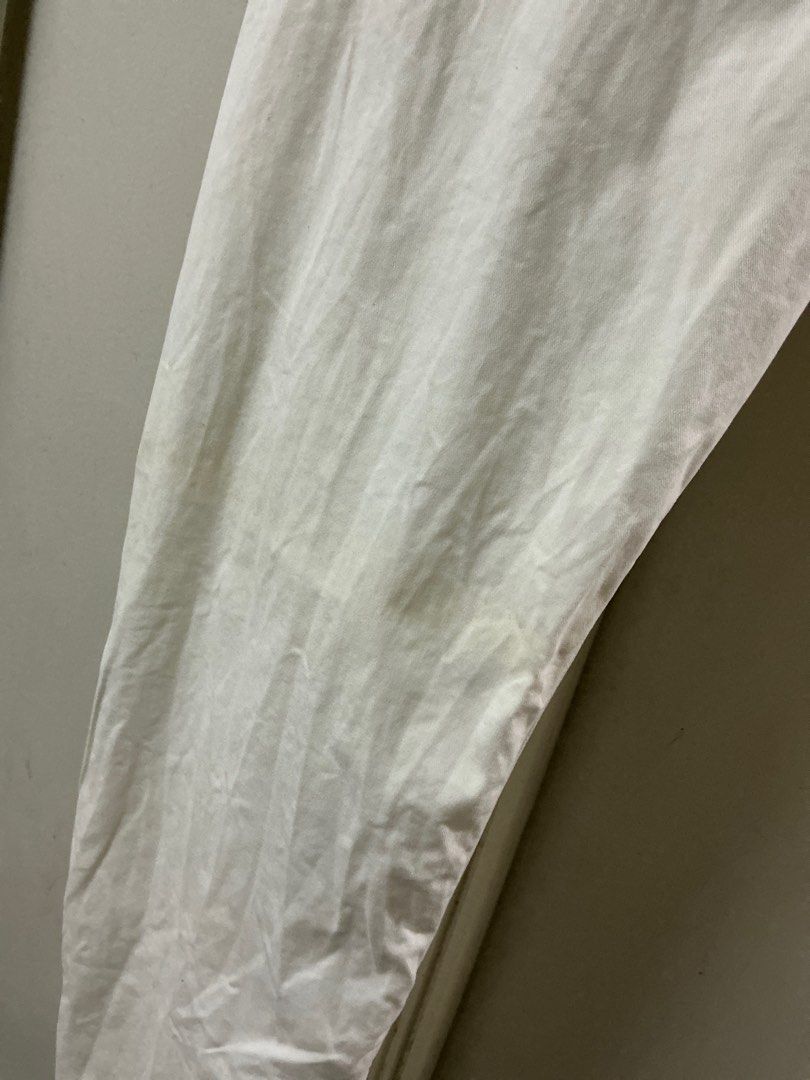 Uniqlo White Jeans Size 34 (Category: Chinos) located in Manila. Submitted by harbs05 (Listing ID 1415184354, Image 3). Description: - Uniqlo jeans - Size: 34 (86.5cm) - Fit: Straight leg - Closure: Button and zipper - Material: Cotton, spandex, and elastane blend - Has minor stain shown in the photo upclose - Condition: Visible stain.