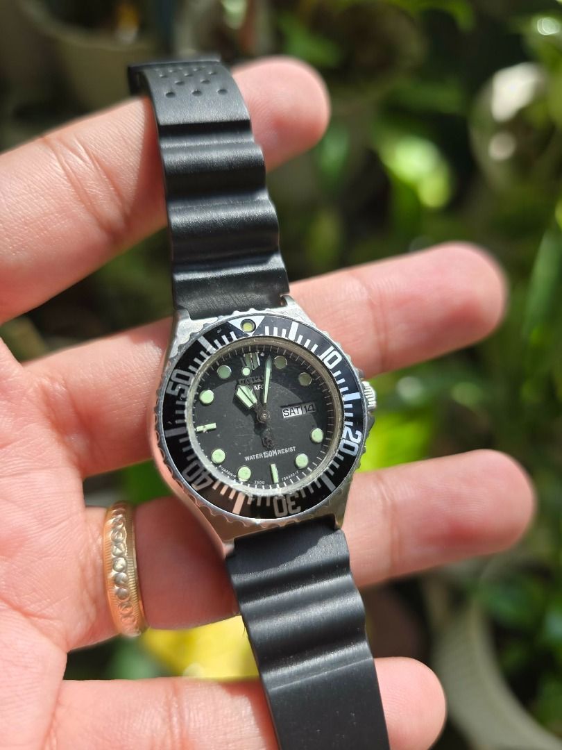 Vintage Citizen Challenge Diver 150M watch (Category: Men's Watches) located in Manila. Submitted by timearcph (Listing ID 1415183530, Image 2). Description: This is a vintage Citizen Challenge Diver 150M watch. The watch features a black dial and a black unidirectional rotating bezel. It has a water resistance rating of 150 meters. The watch is powered by a quartz movement. It includes a day-date complication, displaying "SAT 14" in the image. S