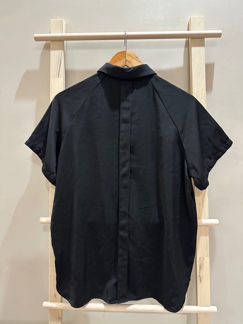 Bench Black Short Sleeve Shirt XL (Category: Shirts) located in Quezon City. Submitted by alloriginalthrift (Listing ID 1415355015, Image 2). Description: Black short sleeve shirt from Bench. It has a collared neckline and button-down front. Still in very good condition. Made of a smooth, likely synthetic fabric..