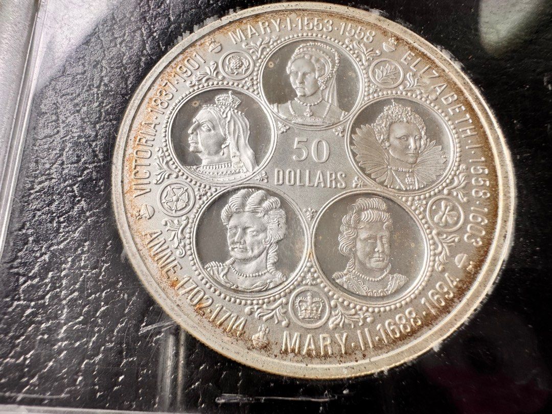 Cayman Islands 50 Dollars Coin 1976 (Category: Currency) located in Manila. Submitted by flojo1220 (Listing ID 1415277849, Image 3). Description: - collectible coins for sale. - 1976 Cayman Islands coin featuring Queen Elizabeth II. - back indicates 50 dollars with portraits of five queens: Victoria, Mary I, Elizabeth I, Anne, and Mary II. - encased in protective holder - sealed, never opened.