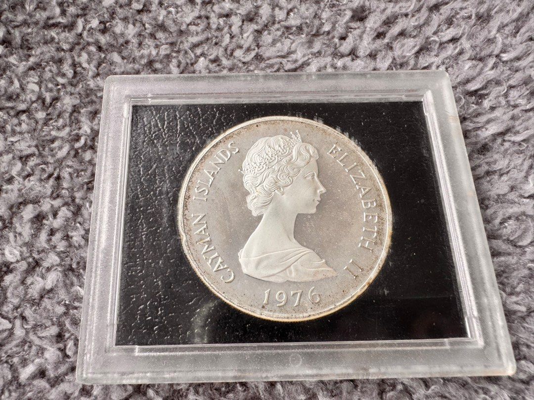 Cayman Islands 50 Dollars Coin 1976 (Category: Currency) located in Manila. Submitted by flojo1220 (Listing ID 1415277849, Image 2). Description: - collectible coins for sale. - 1976 Cayman Islands coin featuring Queen Elizabeth II. - back indicates 50 dollars with portraits of five queens: Victoria, Mary I, Elizabeth I, Anne, and Mary II. - encased in protective holder - sealed, never opened.