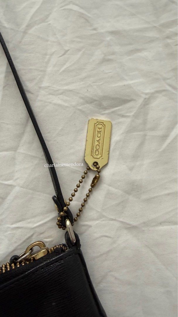 Coach Kitt Crossbody Bag (Category: Luxury Bags & Wallets) located in Pasay City. Submitted by lainedeclutters (Listing ID 1415246048, Image 3). Description: - Black Coach crossbody bag - Gold-tone hardware (7/10) - Zip closure (8/10) - Detachable strap - Interior pocket - Small Coach tag - Minimalist design - Perfect for everyday use - Small Coach logo on front Tarnishings are visible. Please see all photos. No edits made..