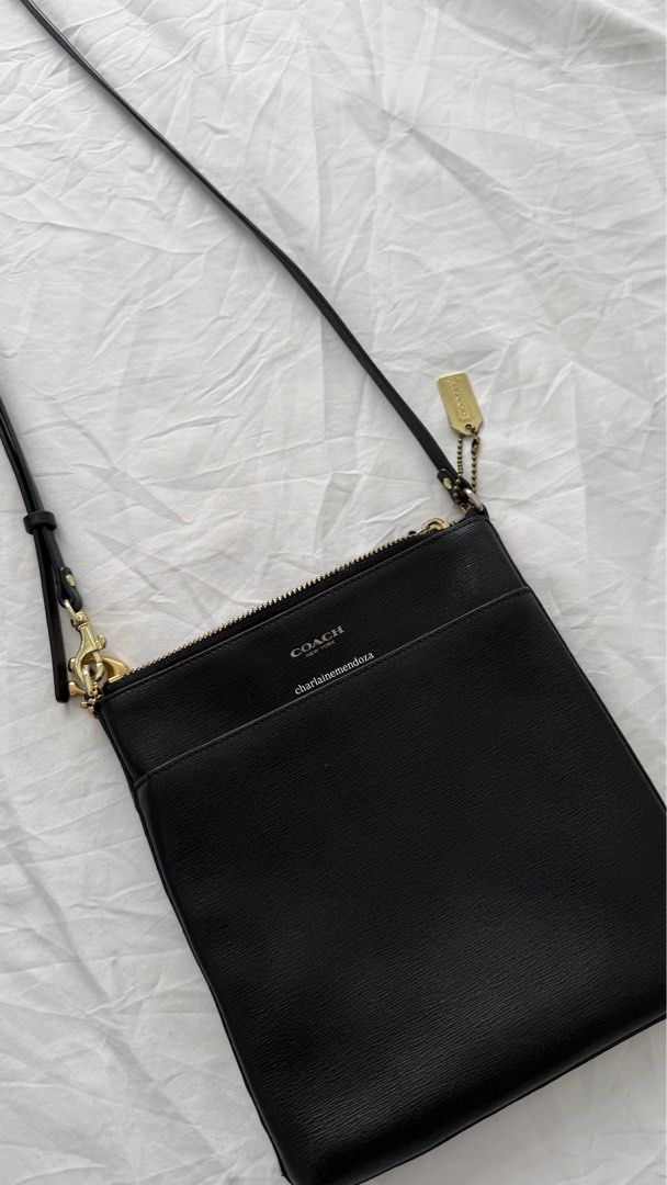Coach Kitt Crossbody Bag (Category: Luxury Bags & Wallets) located in Pasay City. Submitted by lainedeclutters (Listing ID 1415246048, Image 1). Description: - Black Coach crossbody bag - Gold-tone hardware (7/10) - Zip closure (8/10) - Detachable strap - Interior pocket - Small Coach tag - Minimalist design - Perfect for everyday use - Small Coach logo on front Tarnishings are visible. Please see all photos. No edits made..