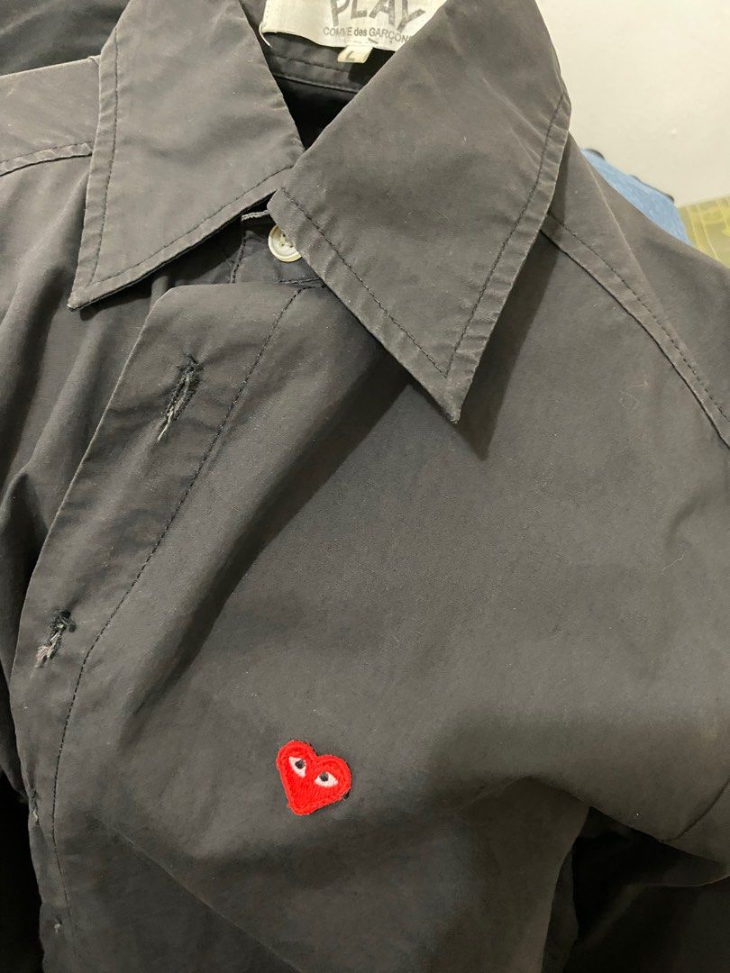 comme des garcons long sleeve black polo (Category: Coats, Jackets and Outerwear) located in Makati City. Submitted by celebrityauctions (Listing ID 1415334992, Image 1). Description: The shirt shown is a Comme des Garçons Play heart logo shirt. This specific item is a black, long-sleeve, button-down shirt featuring the brand’s iconic small red heart emblem with eyes embroidered on the chest. Product Details Brand: Comme des Garçons Play (CDG Pla