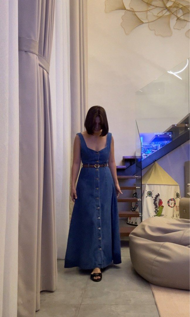 Denim Maxi Dress with Belt (Category: Dresses) located in Manila. Submitted by gettybyrina (Listing ID 1409132582, Image 3). Description: Used 3x. Denim maxi dress features a button-down front, a square neckline, and a matching belt to cinch the waist. It has a sleeveless design and a flowing skirt. It is a versatile piece suitable for various occasions. Helping tags 🏷️ Bershka Zara Mango .