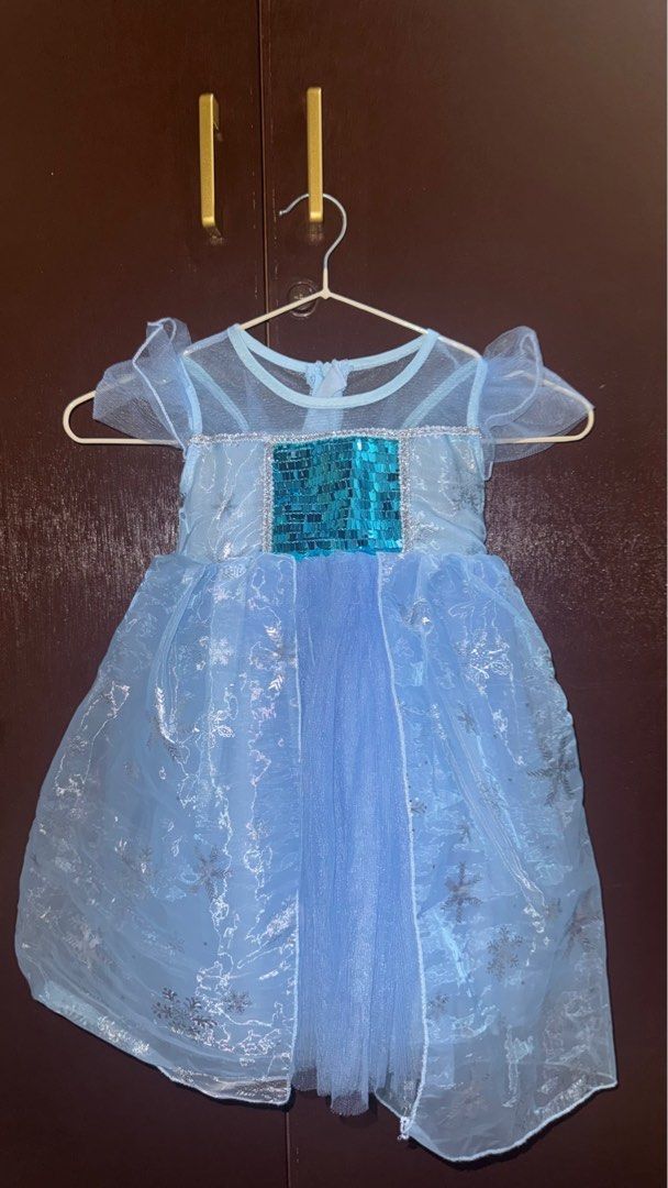Elsa Dress (Category: Babies & Kids Fashion) located in Manila. Submitted by chie_chie_chie (Listing ID 1415334747, Image 1). Description: Beautiful Elsa dress in light blue with silver snowflake details. Features a sequined bodice and sheer sleeves. Perfect for dress-up or themed parties. The dress has a flowing skirt and a delicate design, making it a magical choice for any little princess..