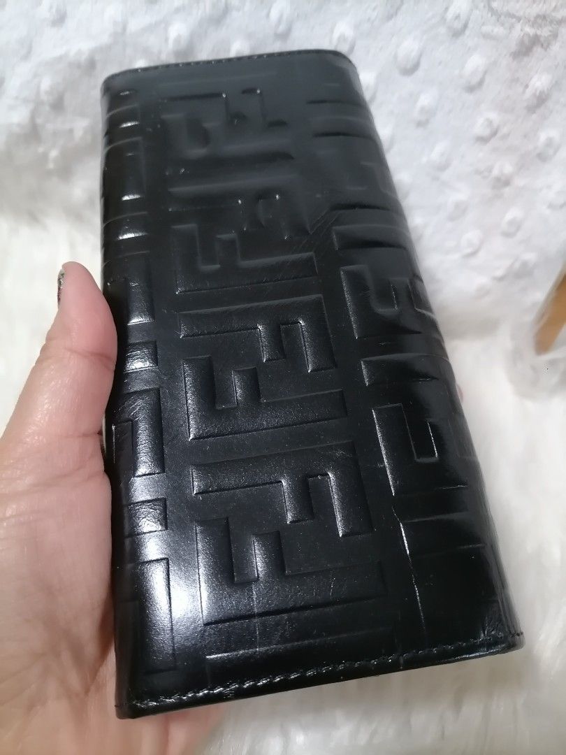 Fendi Black Wallet (Category: Luxury Bags & Wallets) located in Butuan. Submitted by az-branded.items (Listing ID 1415423823, Image 2). Description: - Fendi wallet - Black leather with embossed Fendi logo - Multiple card slots and bill compartments - Snap closure - Gold Fendi logo inside - Minimal signs of wear- visible yung dikit parang may tinanggal pero nasa loob lang hindi napo kita. -No code seen -Selling low -From Korean surplus .