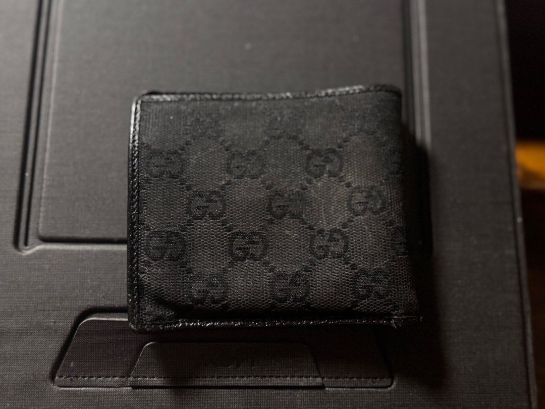 Gucci GG Canvas Wallet (Category: Luxury Bags & Wallets) located in Makati City. Submitted by titaninangfinds (Listing ID 1415310426, Image 2). Description: - Authentic Gucci wallet - Iconic GG pattern - Multiple card slots - Coin pocket - Black leather interior - Some exterior wear - Classic and stylish design.