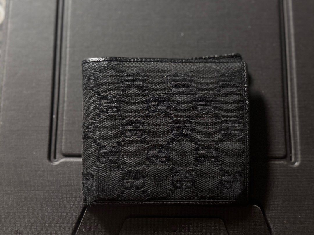 Gucci GG Canvas Wallet (Category: Luxury Bags & Wallets) located in Makati City. Submitted by titaninangfinds (Listing ID 1415310426, Image 1). Description: - Authentic Gucci wallet - Iconic GG pattern - Multiple card slots - Coin pocket - Black leather interior - Some exterior wear - Classic and stylish design.