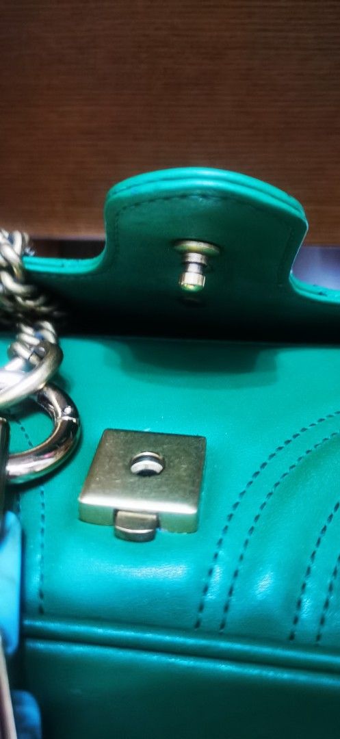 Gucci GG Marmont small Bag Green (Category: Luxury Bags & Wallets) located in Cainta. Submitted by phengaying (Listing ID 1415340649, Image 2). Description: - Gucci GG Marmont Mini Bag - Color: Green - Chain strap with turquoise accents - Flap closure with gold-tone clasp - Interior pocket with Gucci label - Serial number: 446744 101010 & black QR tag -RANK B condition FLAws: - leather damage/tear near the flap -replaced with resin chain extensio